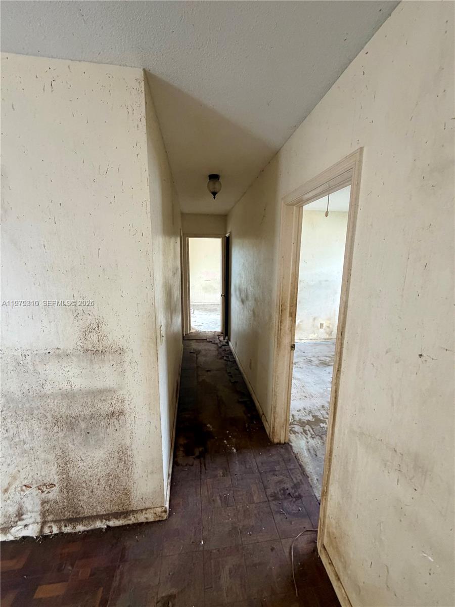 1761 Southwest 55th Avenue Plantation, FL 33317 - Photo 17 of 18 a view of a hallway with wooden floor and a living room