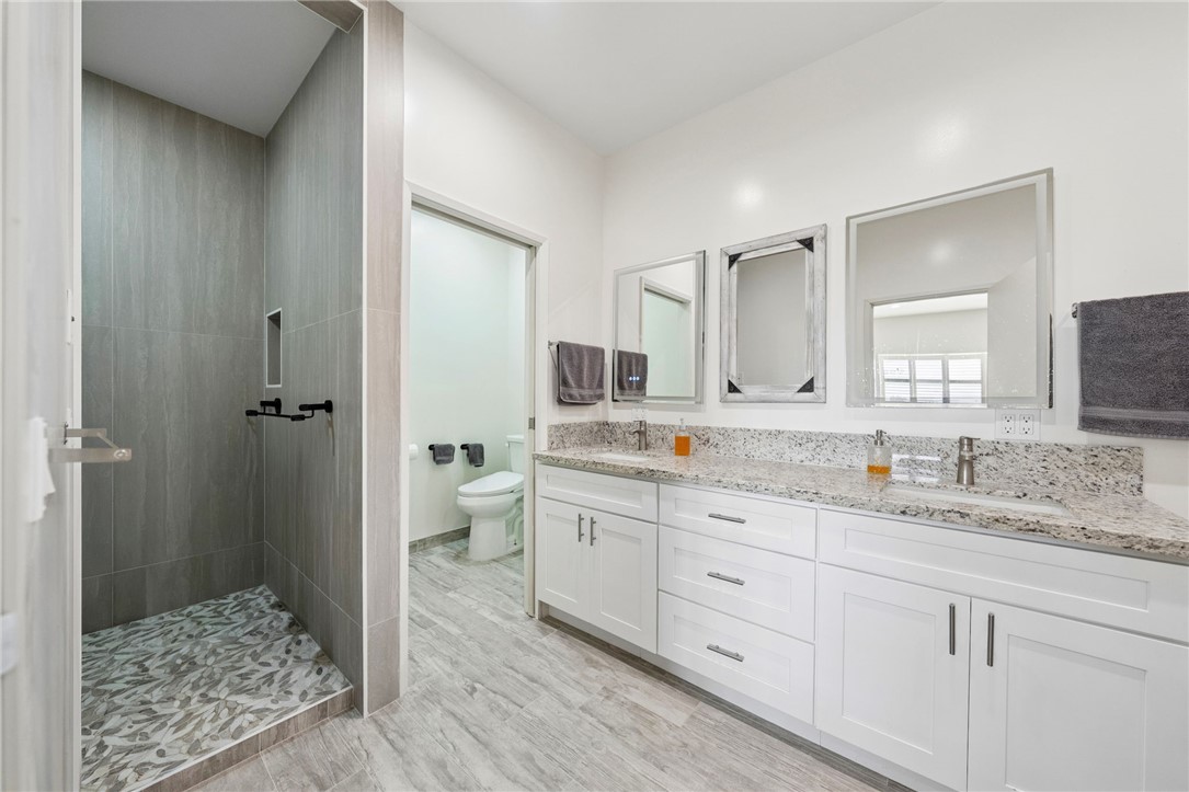 35825 Meadow Ridge Road Temecula, CA 92592 - Photo 72 of 75 a spacious bathroom with a granite countertop sink mirror and toilet