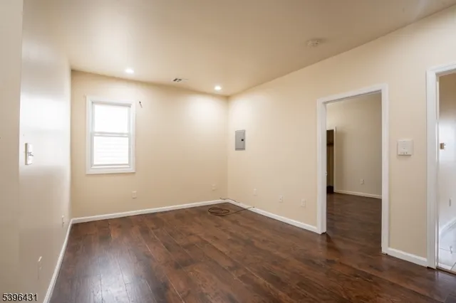 an empty room with wooden floor and closet