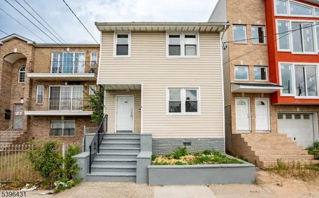 a front view of a house with a yard and sitting area