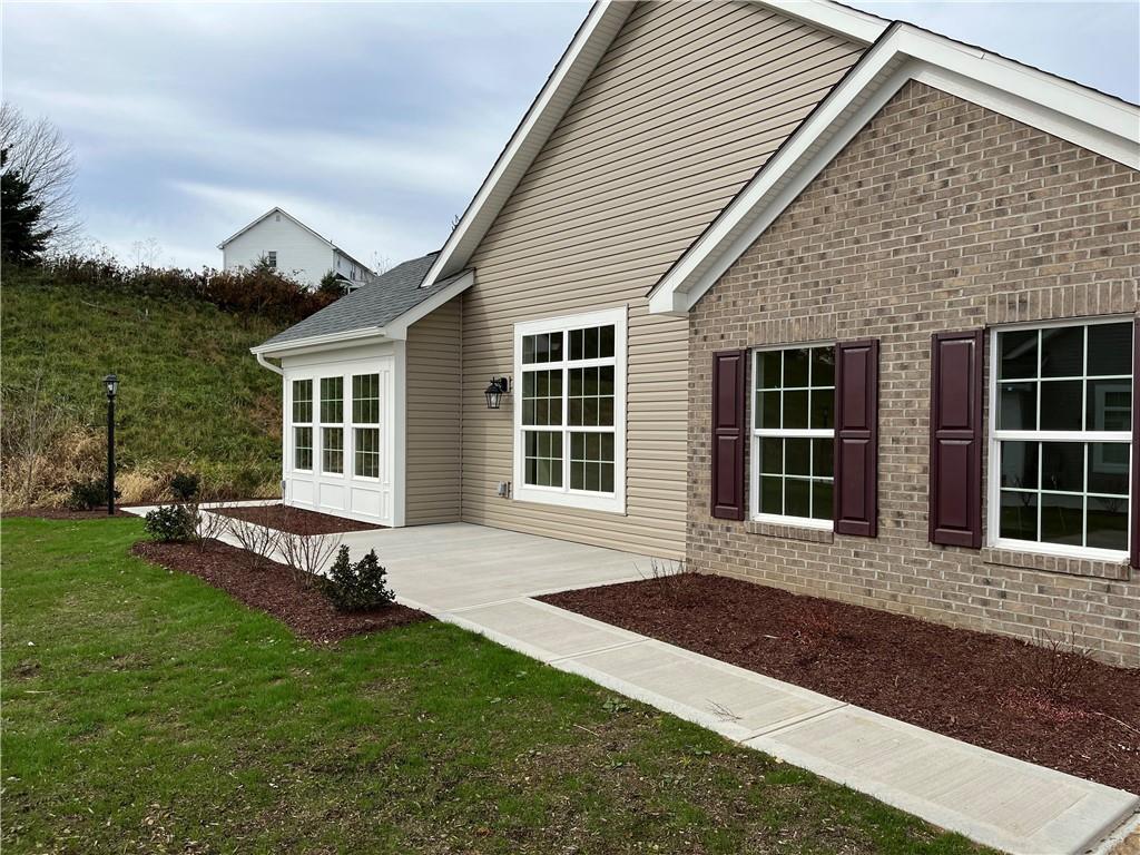 a front view of a house with a garden