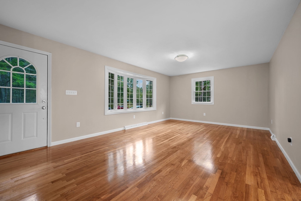 2 Woodland Road Acushnet, MA 02743 - Photo 11 of 26 a view of an empty room with wooden floor and a window
