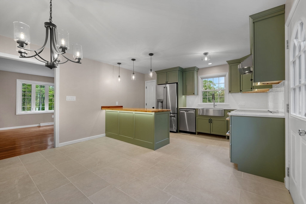 2 Woodland Road Acushnet, MA 02743 - Photo 4 of 26 a view of a kitchen with a sink cabinet and a window