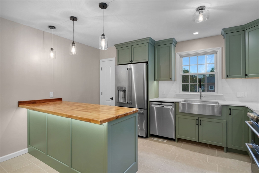 2 Woodland Road Acushnet, MA 02743 - Photo 6 of 26 a kitchen with stainless steel appliances granite countertop a kitchen island a refrigerator and a sink