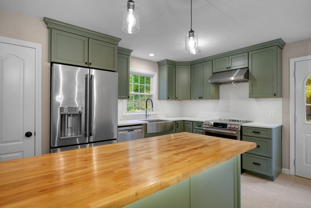 2 Woodland Road Acushnet, MA 02743 - Photo 8 of 26 a kitchen with stainless steel appliances granite countertop a refrigerator a sink and a stove