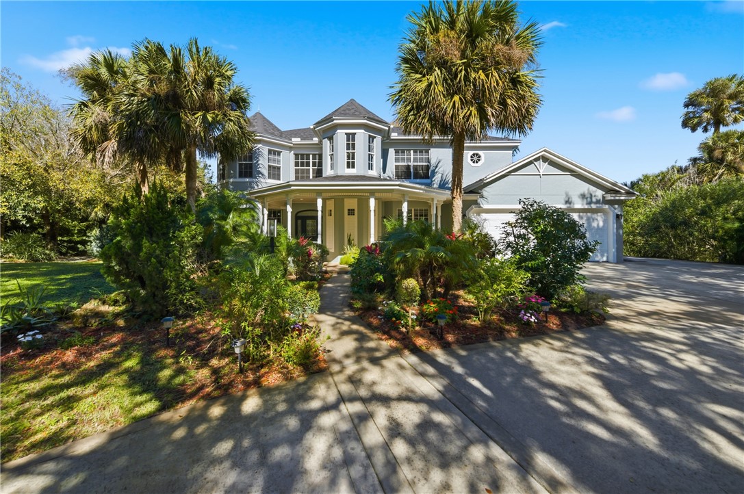 a front view of a house with a garden
