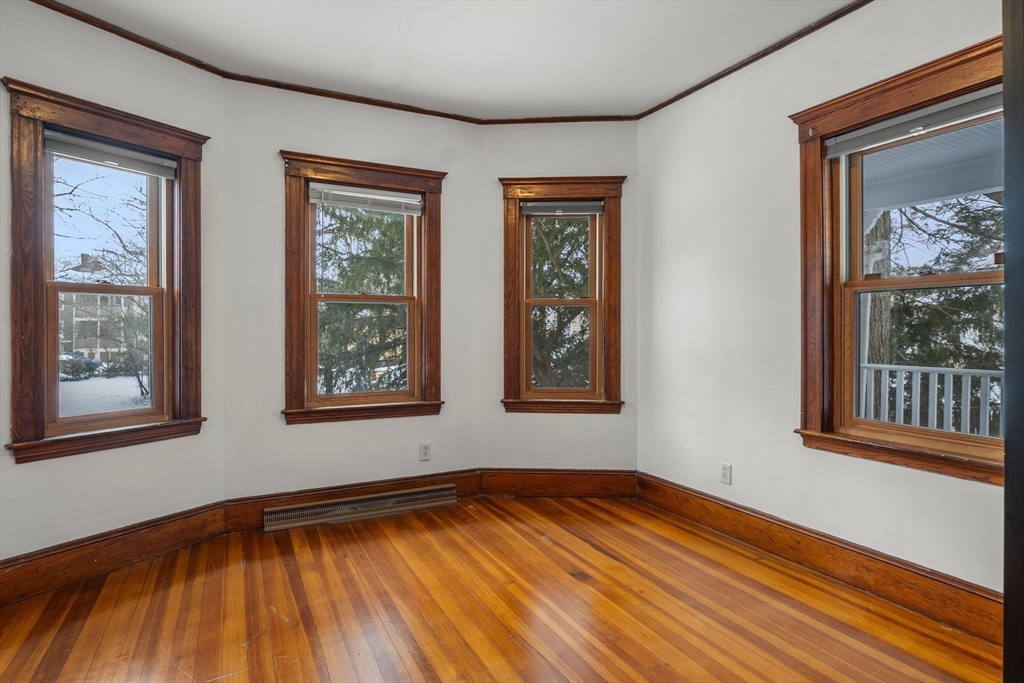 370 R Grove, Unit REAR Boston, MA 02132 - Photo 11 of 21 a view of an empty room with wooden floor and a window