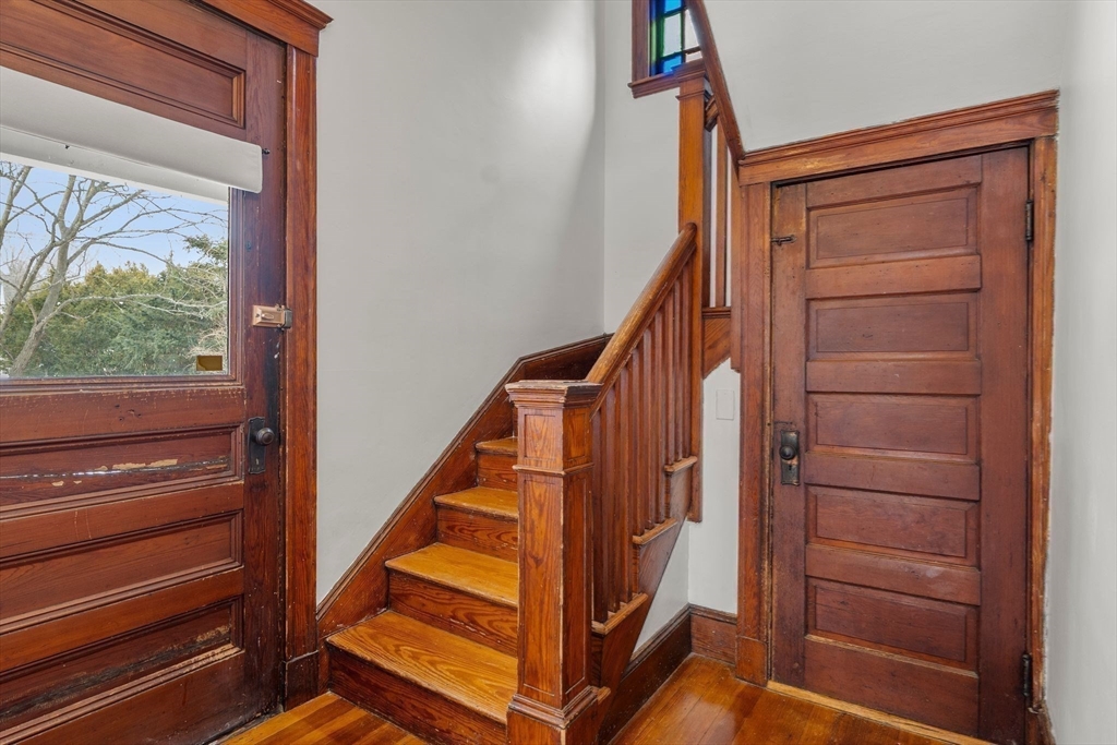 370 R Grove, Unit REAR Boston, MA 02132 - Photo 14 of 21 a view of staircase with wooden floor and white walls