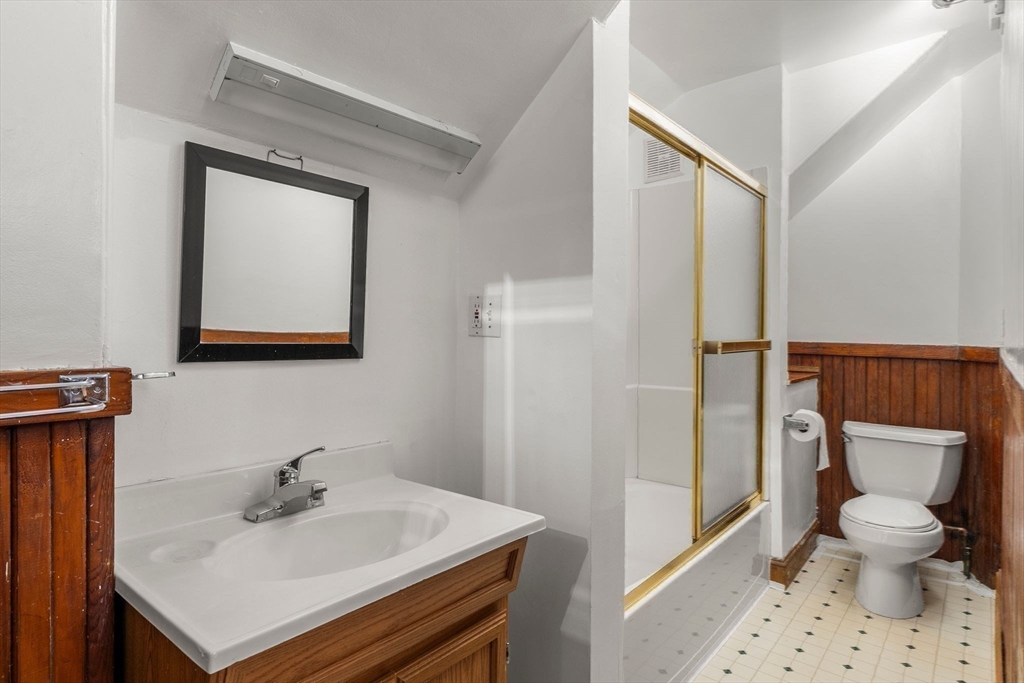 370 R Grove, Unit REAR Boston, MA 02132 - Photo 15 of 21 a bathroom with a sink a toilet and a mirror