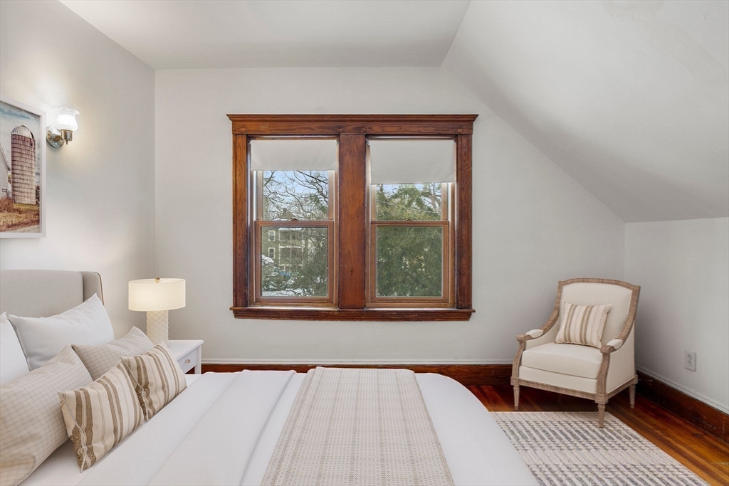 370 R Grove, Unit REAR Boston, MA 02132 - Photo 17 of 21 a bedroom with a bed and a couch