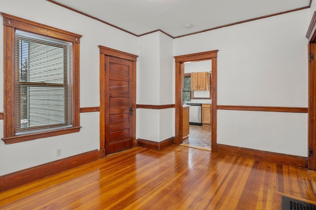 370 R Grove, Unit REAR Boston, MA 02132 - Photo 8 of 21 a view of a room with wooden floor and a window
