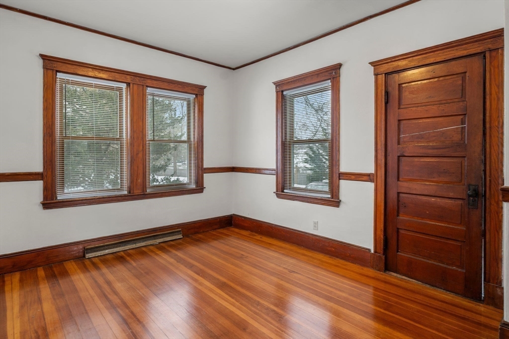 370 R Grove, Unit REAR Boston, MA 02132 - Photo 9 of 21 a view of an empty room with window and wooden floor