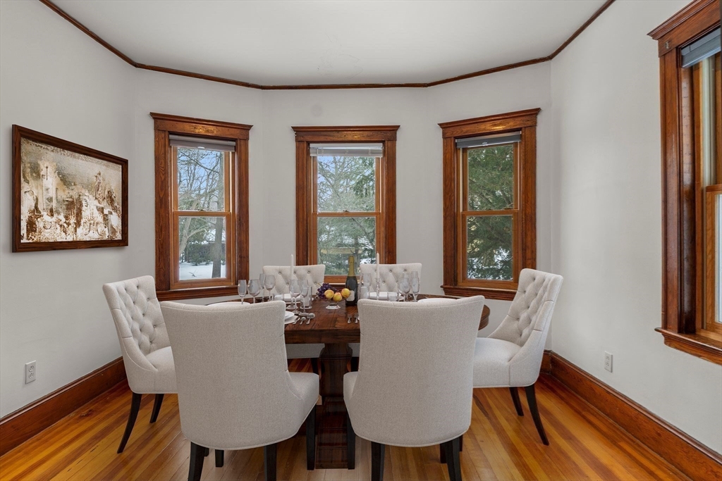 370 R Grove, Unit REAR Boston, MA 02132 - Photo 10 of 21 a view of a dining room with furniture wooden floor and a potted plant