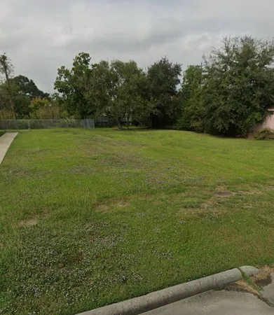 a view of a field with an trees in the background