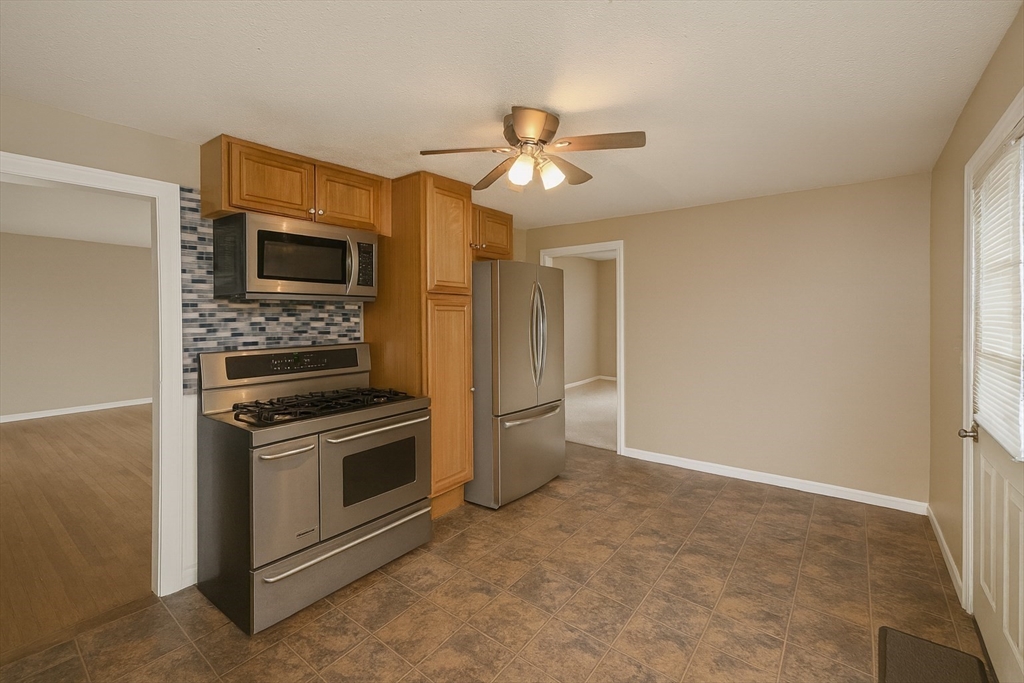 142 Morton Street West Springfield, MA 01089 - Photo 7 of 18 a kitchen with a stove and a microwave