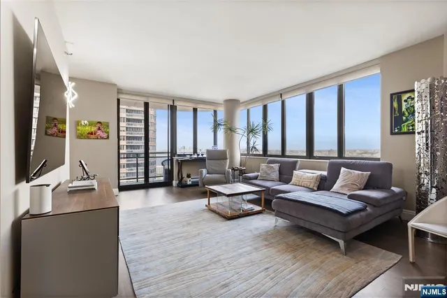 a living room with furniture and a flat screen tv