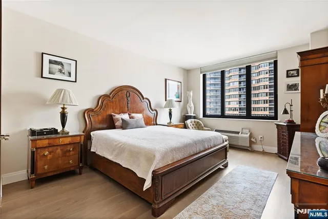 a bedroom with bed and a large window