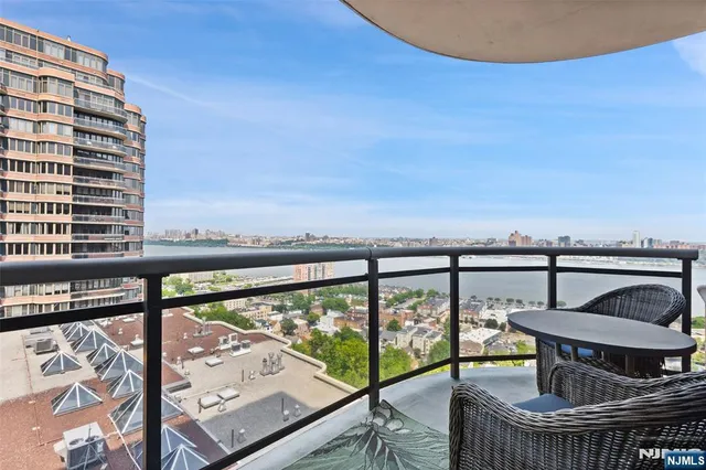 a view of a balcony with wooden chairs