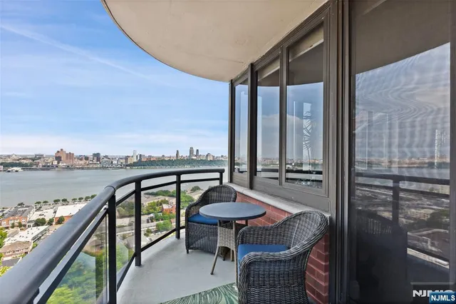 a view of a balcony with chairs and a table