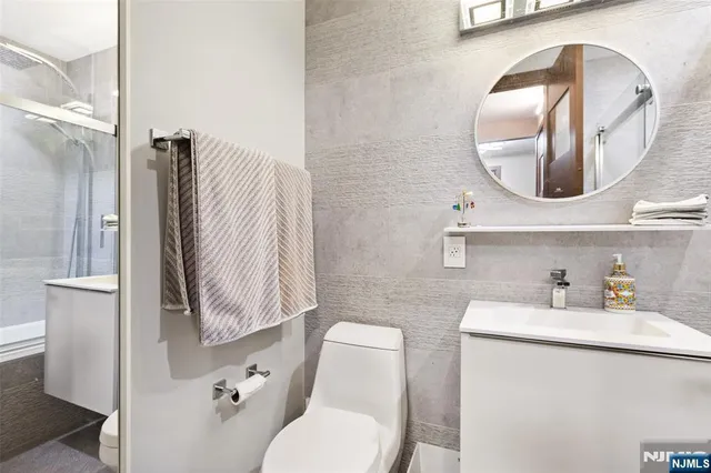 a bathroom with a toilet sink and mirror