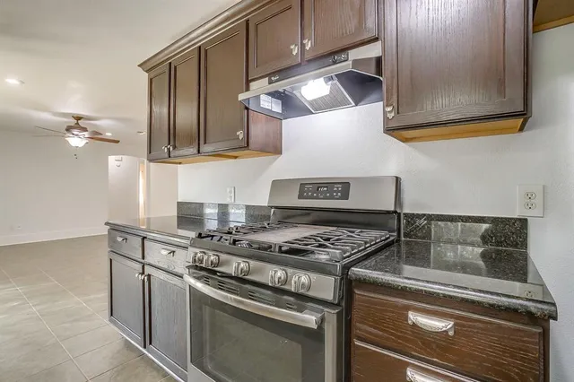 a kitchen with stainless steel appliances granite countertop a stove and a microwave