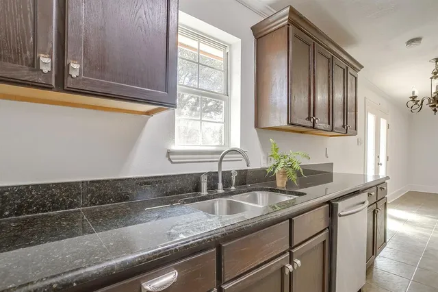 a kitchen with granite countertop a sink and a window
