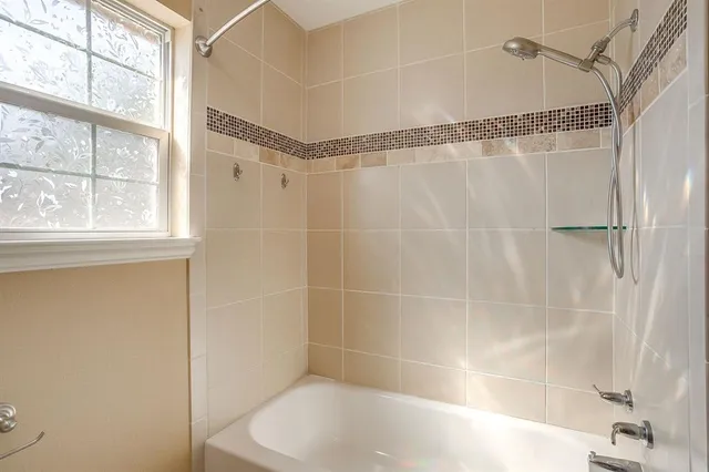 a bathroom with a shower and a window