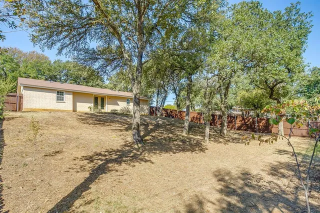 a view of a house with a yard covered in snow