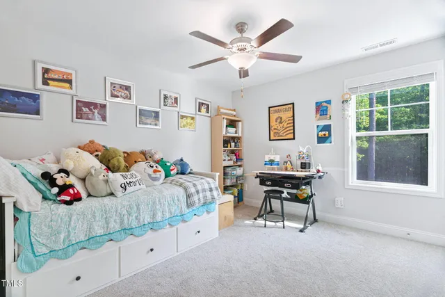 an aerial view of a residential houses with outdoor space and trees