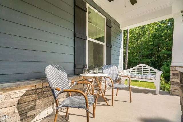 an aerial view of a house with swimming pool and large trees