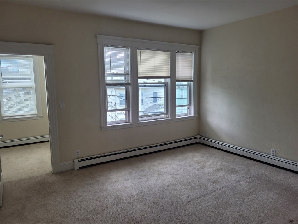 39 Irving Street, Unit 4 Everett, MA 02149 - Photo 3 of 8 an empty room with a window