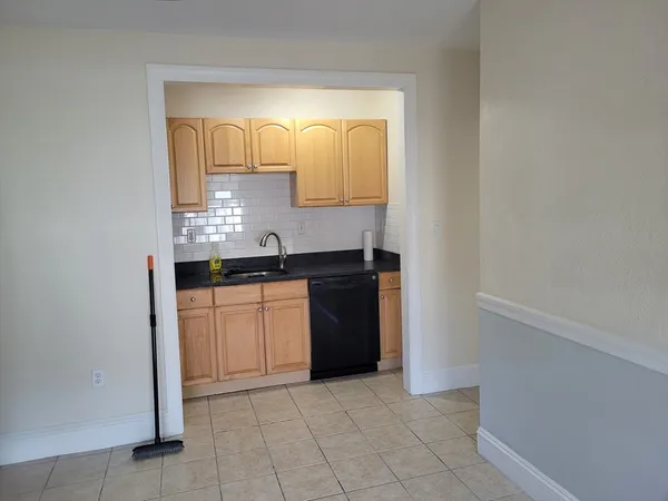 a kitchen with a refrigerator and cabinets
