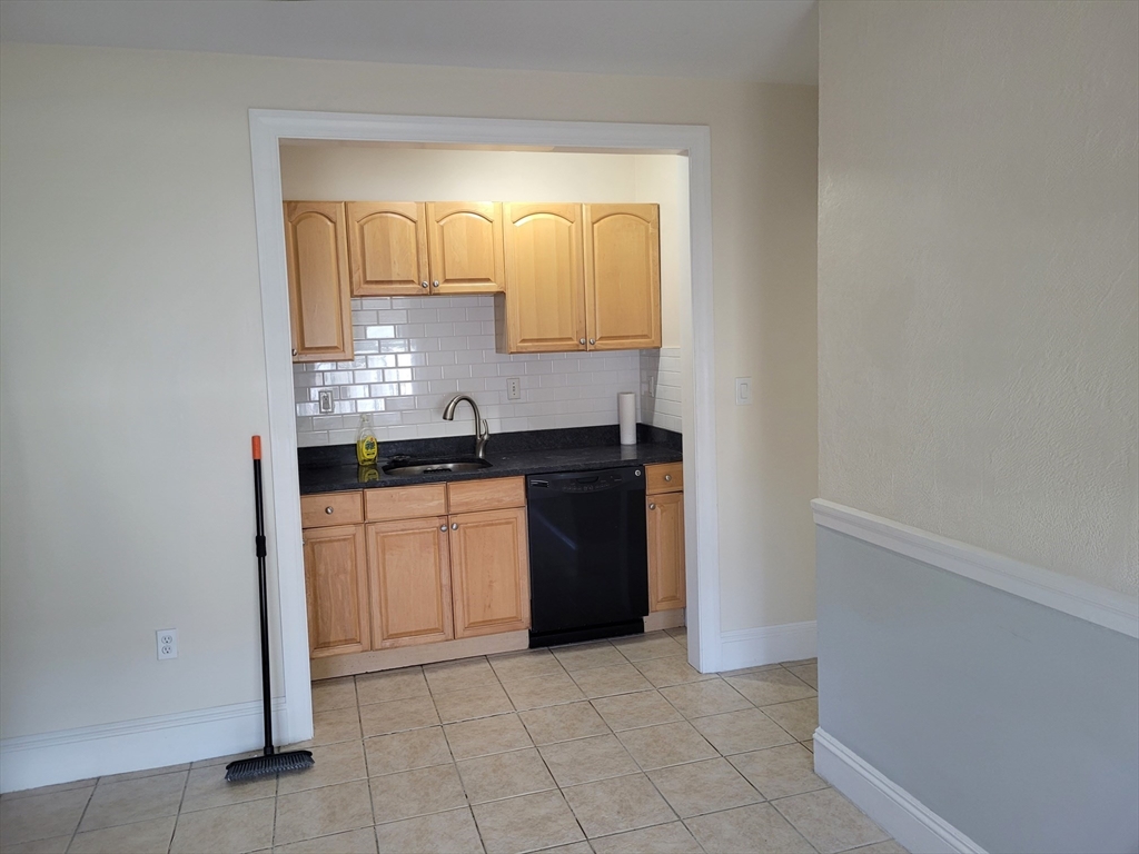 39 Irving Street, Unit 4 Everett, MA 02149 - Photo 7 of 8 a kitchen with a refrigerator and cabinets