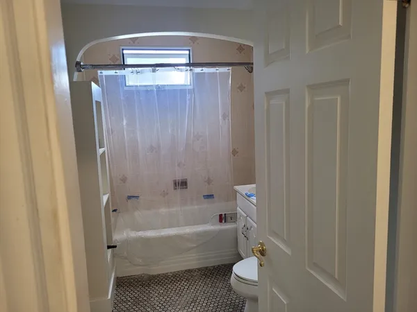 a bathroom with a bathtub a toilet and a shower