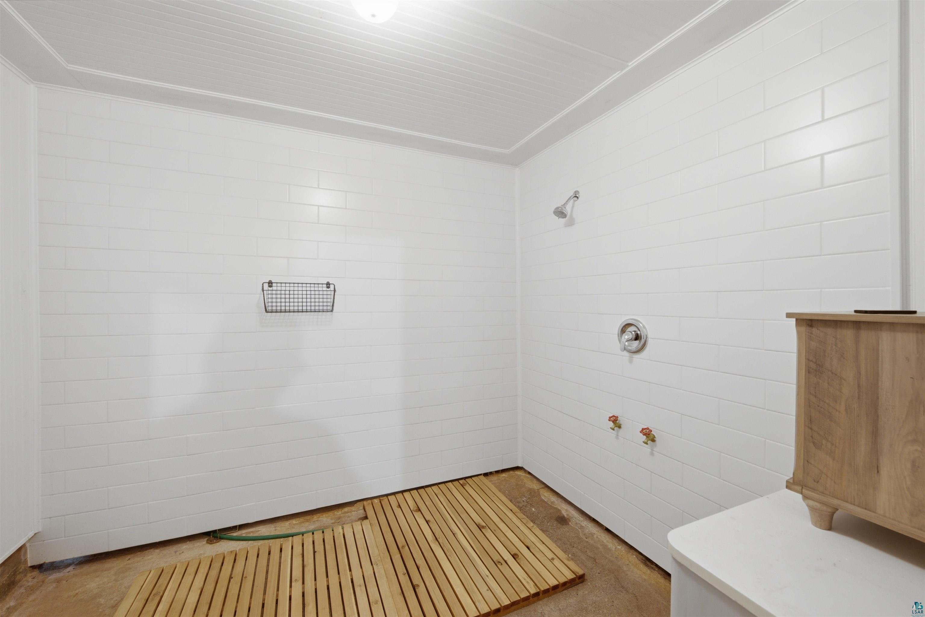 64260 Jolma Road Ashland, WI 54806 - Photo 23 of 35 White subway tile walls with a chrome shower head and central control