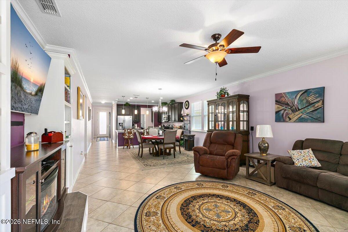 53 Monroe Avenue St. Augustine, FL 32086 - Photo 13 of 26 a living room with furniture ceiling fan and a rug