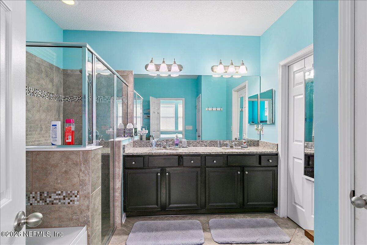53 Monroe Avenue St. Augustine, FL 32086 - Photo 16 of 26 a bathroom with a granite countertop sink and a mirror