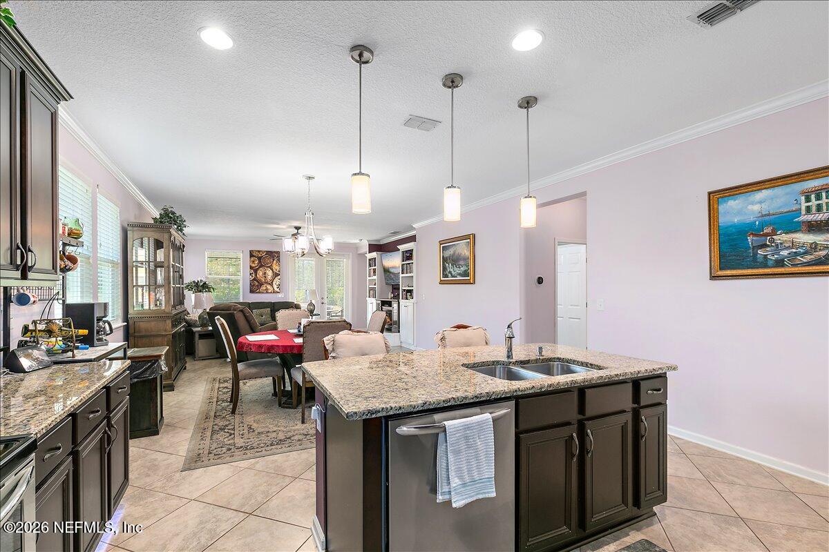 53 Monroe Avenue St. Augustine, FL 32086 - Photo 7 of 26 a open kitchen with a sink a stove and a wooden floors