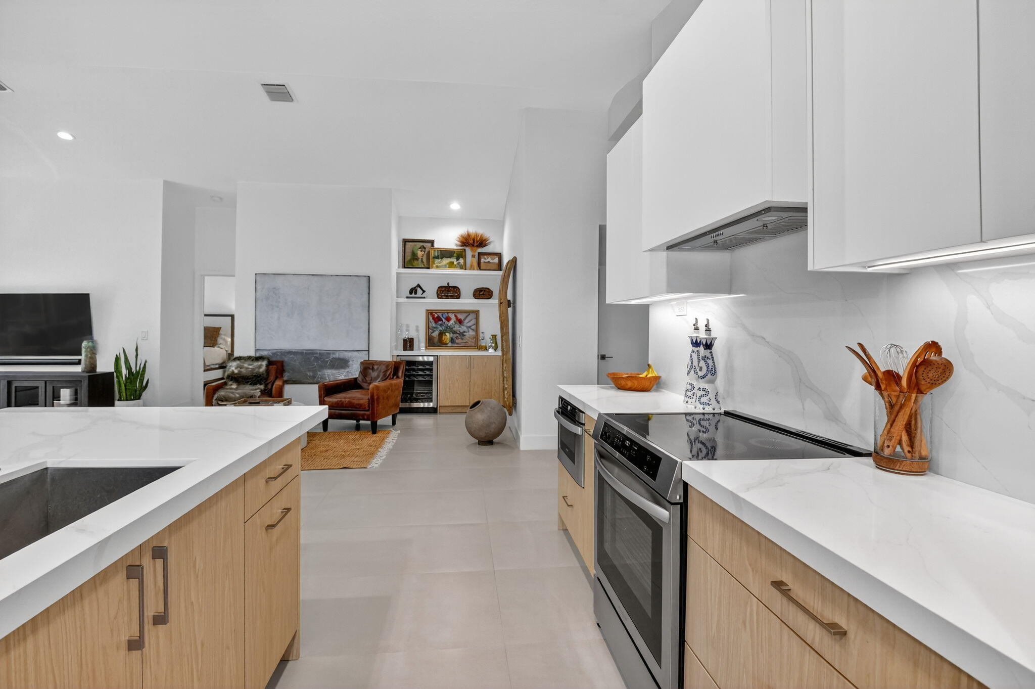 1175 Sea Grape Circle Delray Beach, FL 33445 - Photo 13 of 64 a kitchen with a sink a stove and cabinets