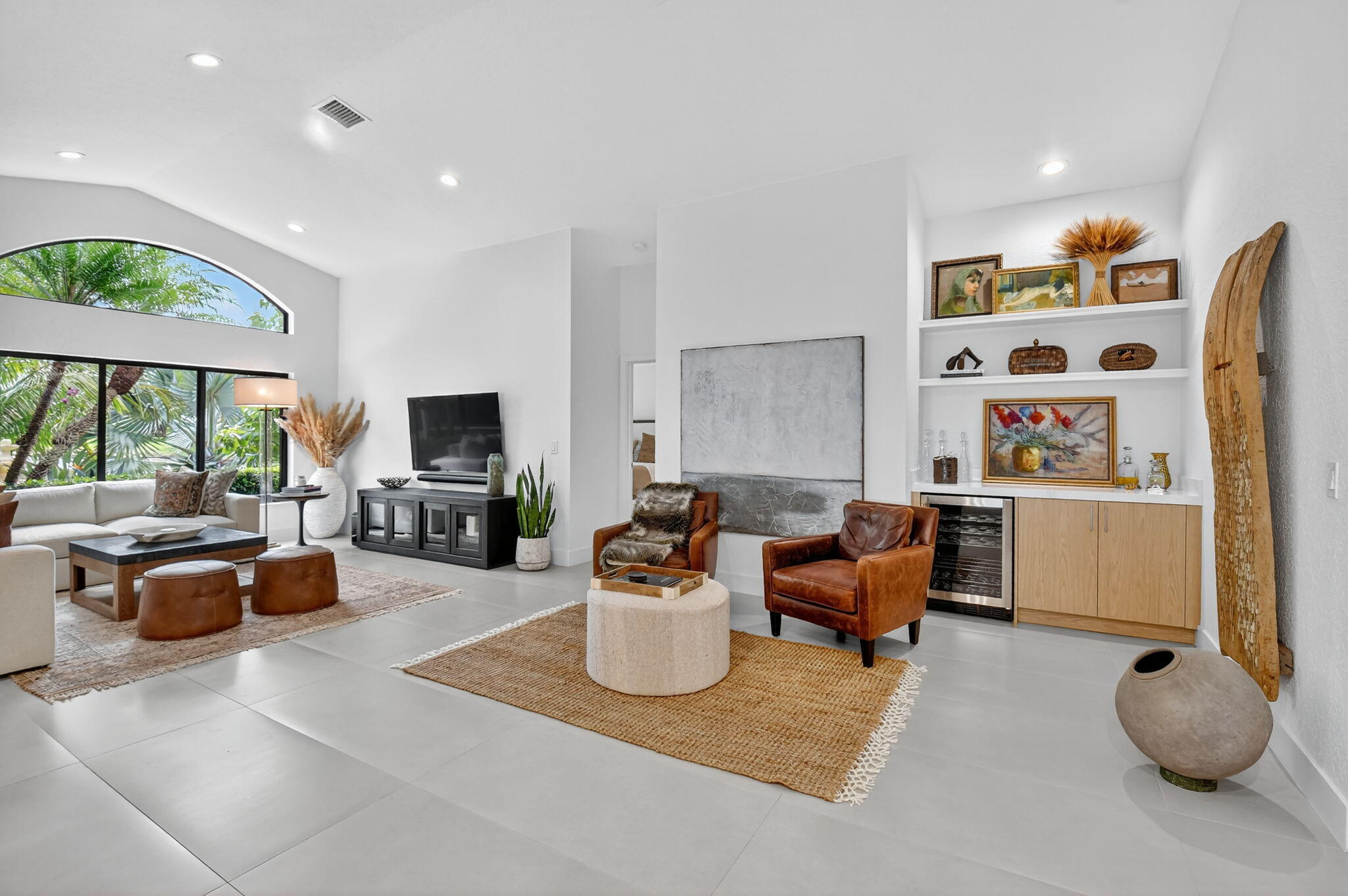 1175 Sea Grape Circle Delray Beach, FL 33445 - Photo 14 of 64 a living room with furniture a flat screen tv and a floor to ceiling window