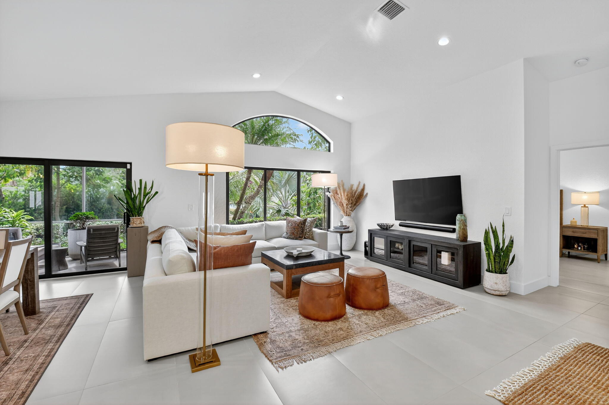 1175 Sea Grape Circle Delray Beach, FL 33445 - Photo 16 of 64 a living room with furniture a flat screen tv and a large window