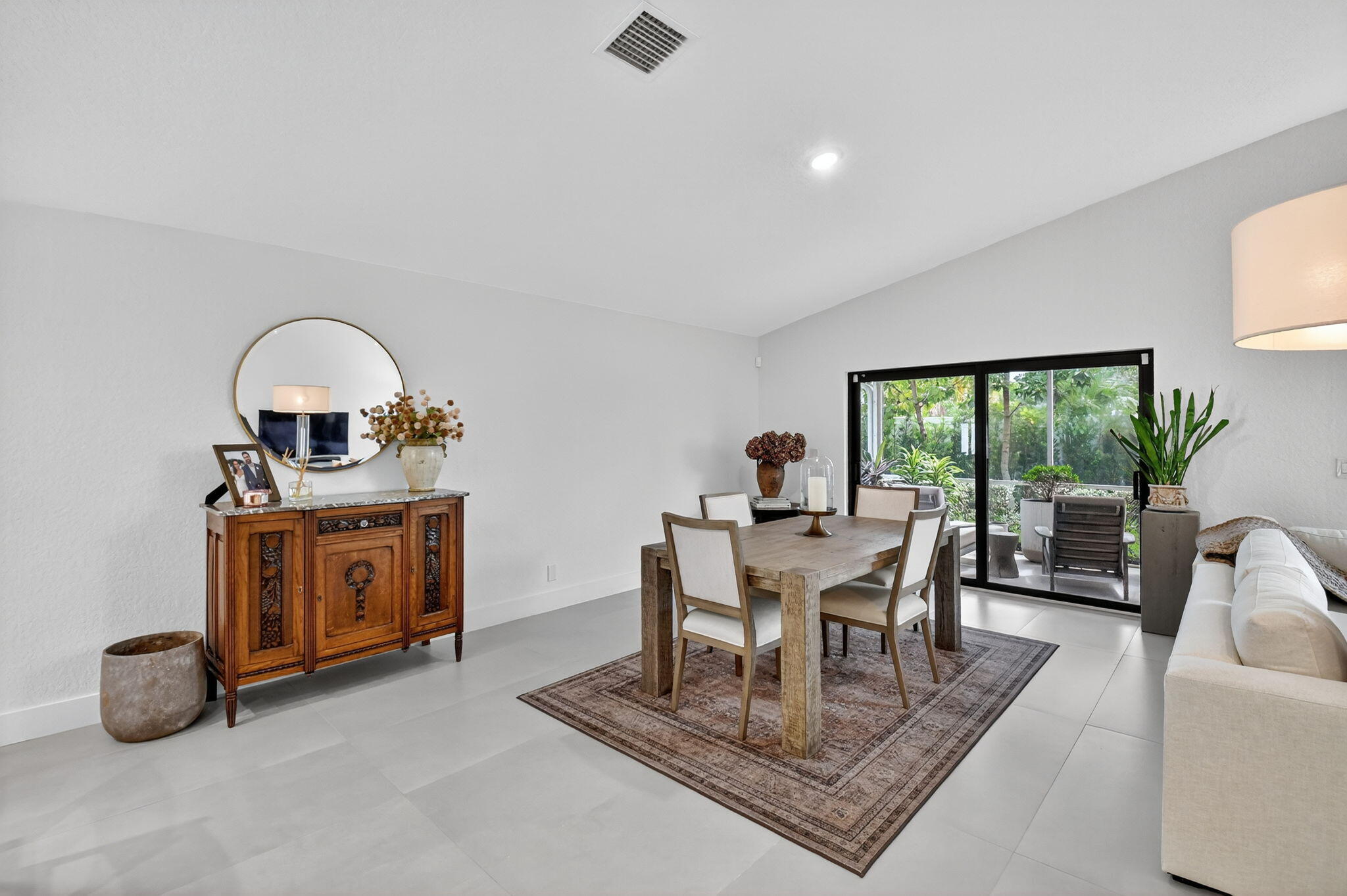 1175 Sea Grape Circle Delray Beach, FL 33445 - Photo 17 of 64 a living room with furniture a window and a chandelier