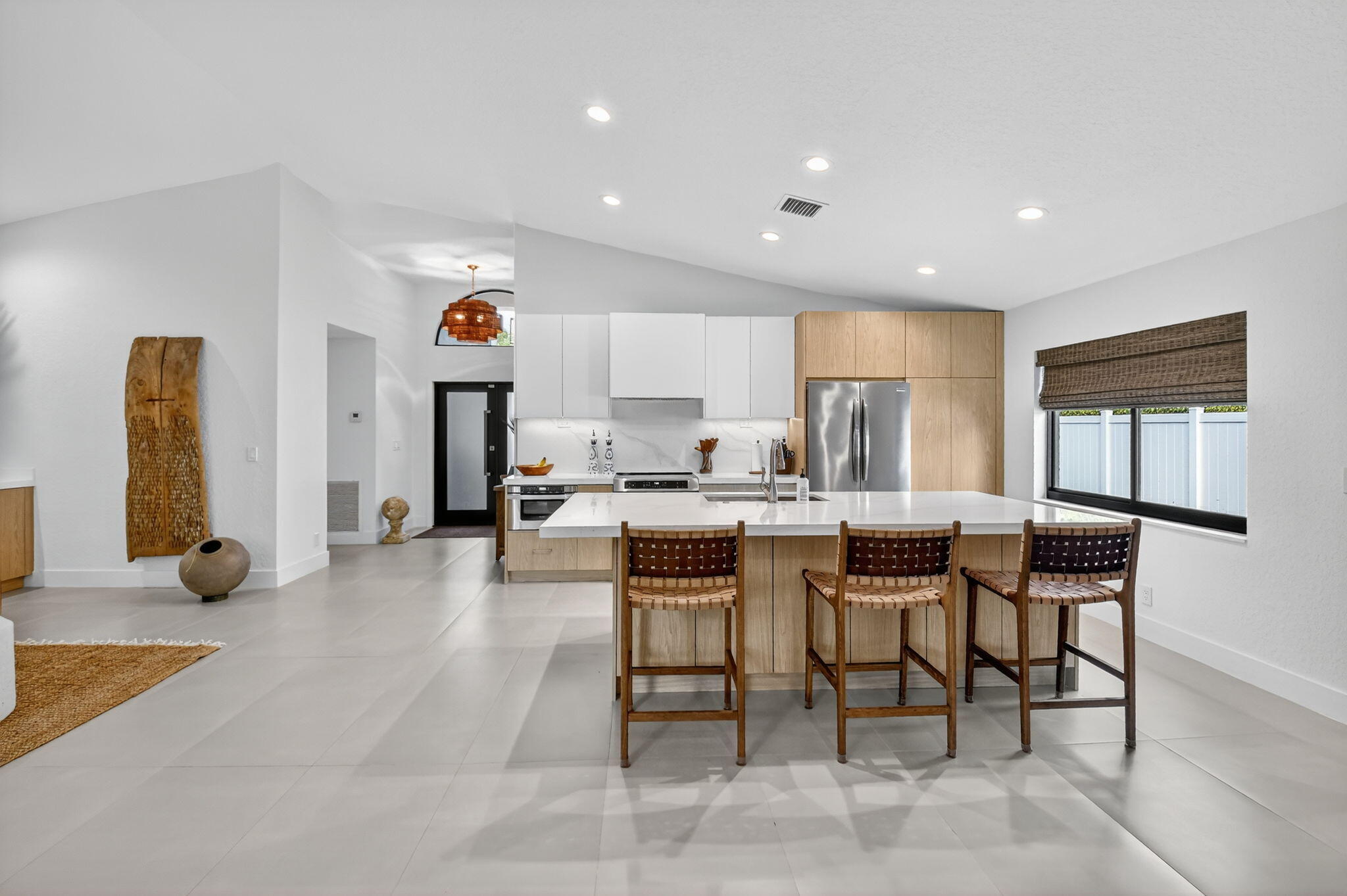 1175 Sea Grape Circle Delray Beach, FL 33445 - Photo 21 of 64 a large kitchen with a table and chairs in it