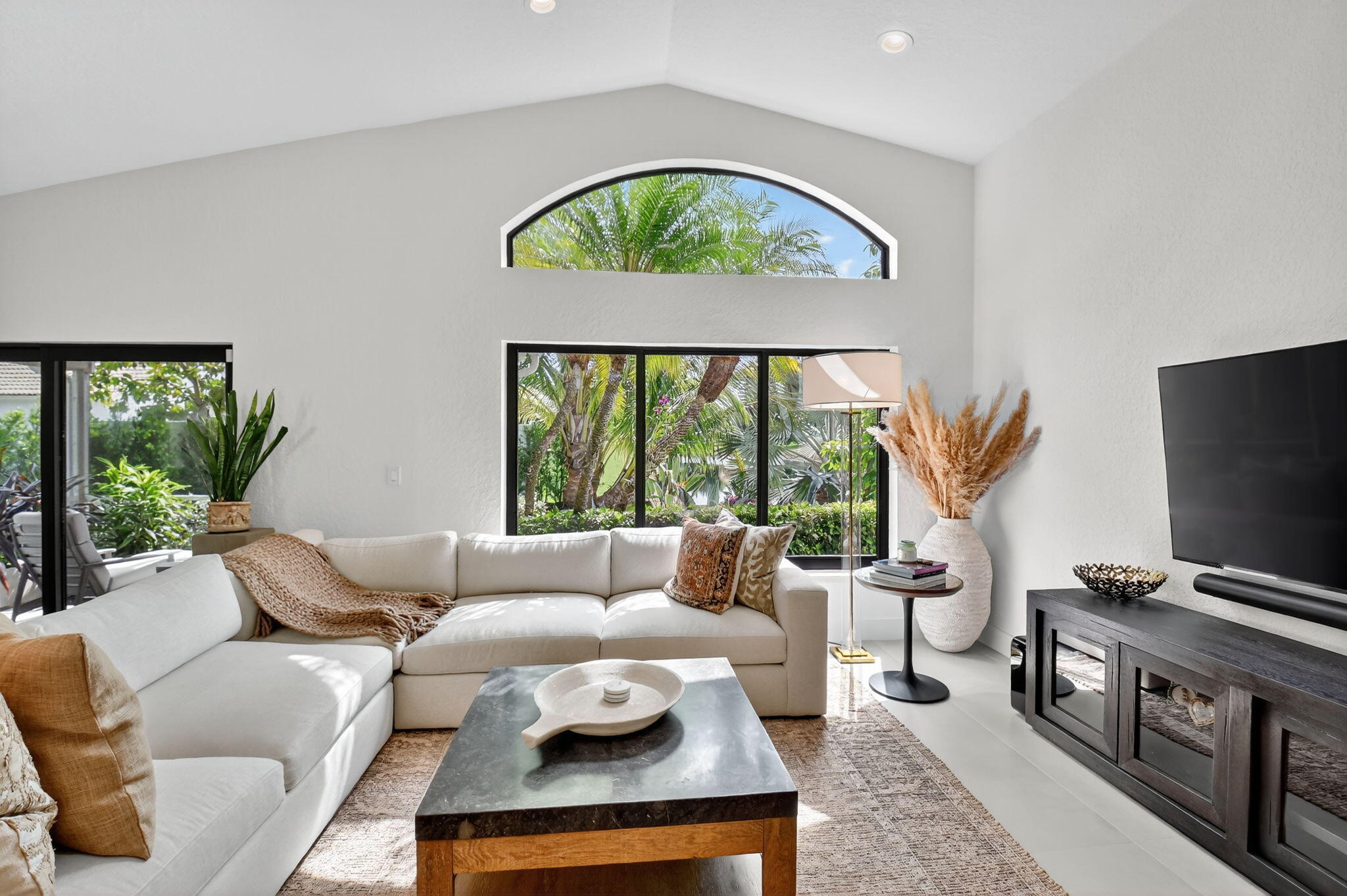 1175 Sea Grape Circle Delray Beach, FL 33445 - Photo 25 of 64 a living room with furniture a window and a flat screen tv