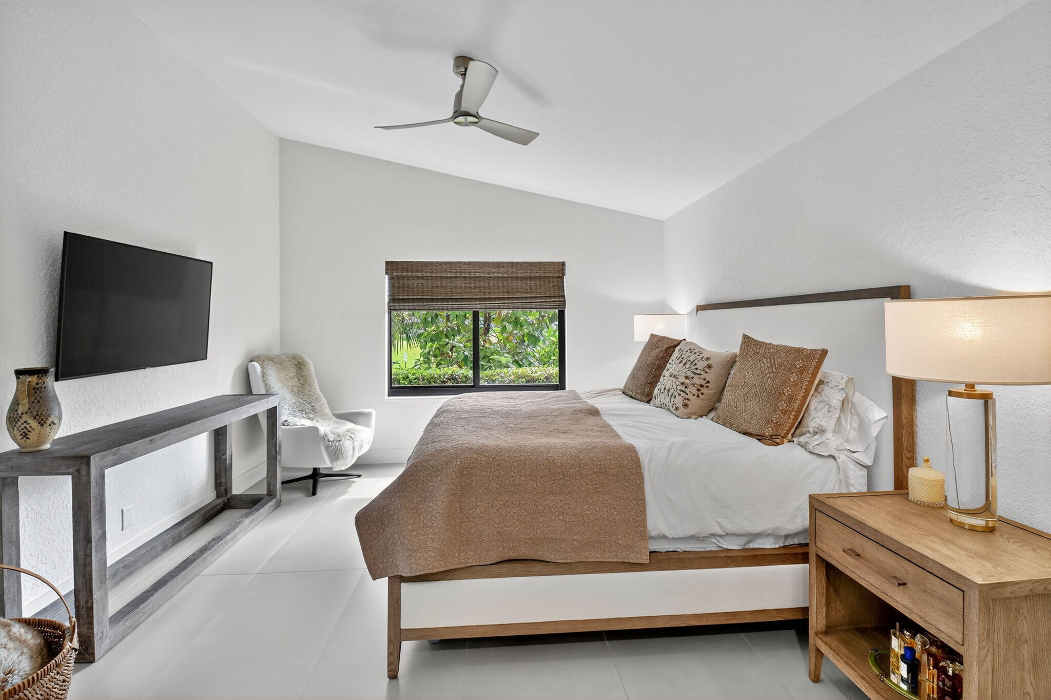 1175 Sea Grape Circle Delray Beach, FL 33445 - Photo 28 of 64 a bedroom with a bed and a flat screen tv