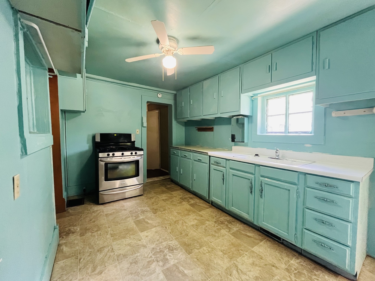 1213 East Main Street Streator, IL 61364 - Photo 15 of 18 a kitchen with stainless steel appliances a sink cabinets and a refrigerator
