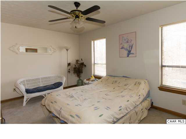51 Dogleg Road Palmyra, VA 22963 - Photo 10 of 19 a bedroom with a bed window and a chair
