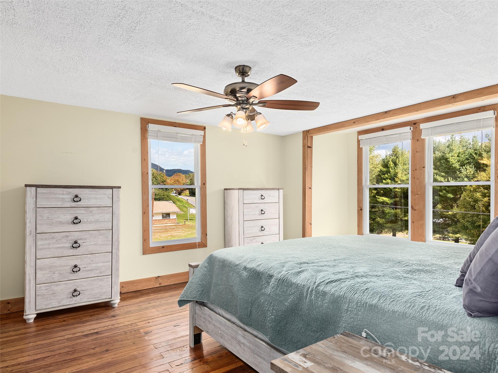 1426 Poison Cove Road Clyde, NC 28721 - Photo 8 of 12 a bedroom with a large bed and a dresser