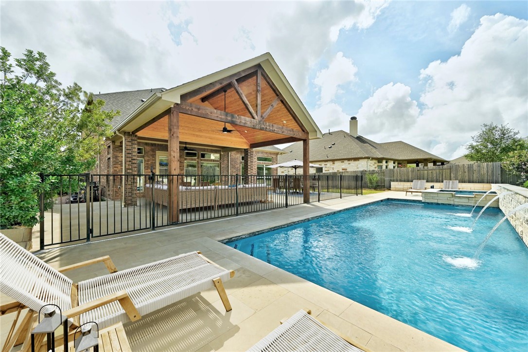 a view of a house with swimming pool and sitting area