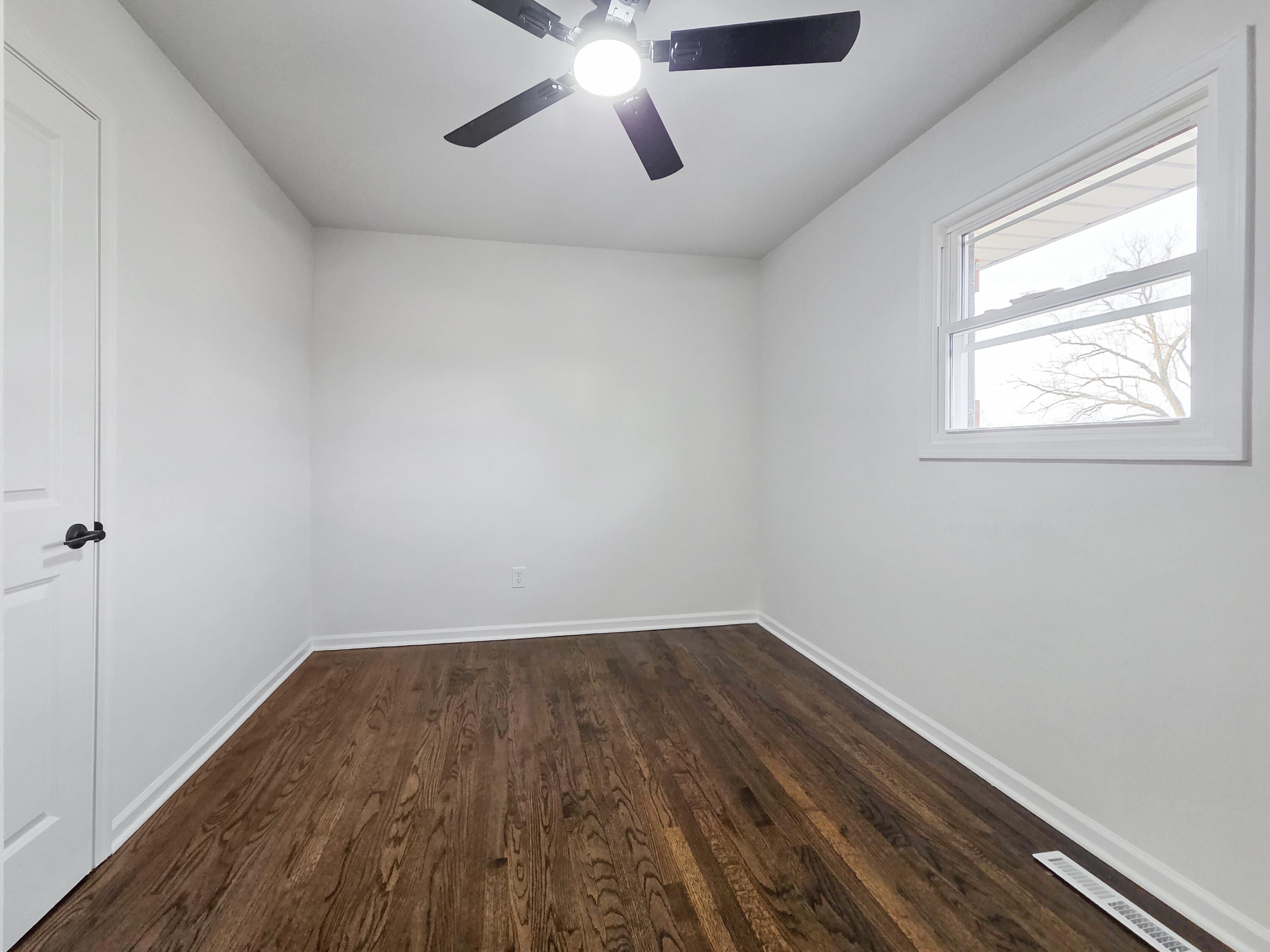1629 Tennessee Street Gary, IN 46407 - Photo 14 of 26 wooden floor in an empty room with a window